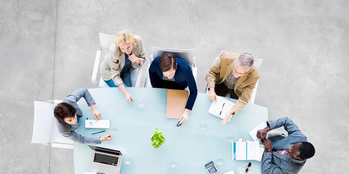 An image showing a team discussion in a board room